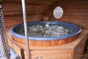 Ovale buitensauna met geintegreerd bubbelbad 49